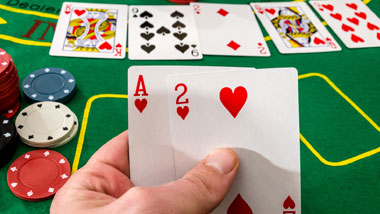 fingers holder cards, cards and chips on table