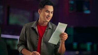 Man writing his picks down at the Sportsbook.