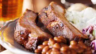 ribs with baked beans, coleslaw and a beer